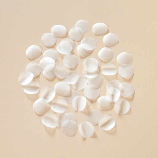 White circle biodegradable confetti pieces arranged on a beige background - The Confetti Farm